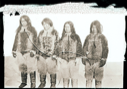 Image of Four Inuit [Inughuit] men [Seegloo (Sigluk), Ootah (Odaq), Egingwah (Iggianguaq), Ooqueeah (Ukkaujaaq)] stand in row
